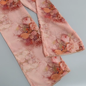 Detail of pink floral chiffon fabric showing delicate print and soft semi-transparent texture
