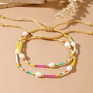 Detailed macro view of handmade multi-colored seed bead bracelet with natural pearls