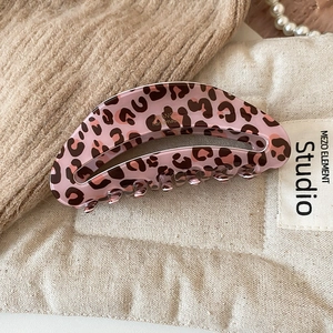 Macro detail of pink leopard print hair claw clip showing the France handmade mark