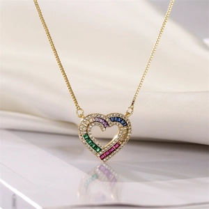 Close-up of gold heart pendant with colorful rectangular gemstones on a box chain
