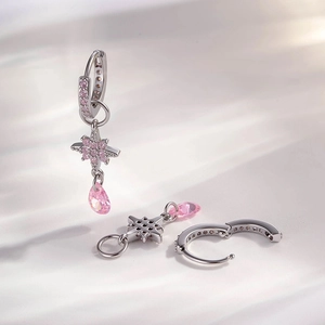 Silver star earrings with pink rhinestones and teardrop charms in a refined design