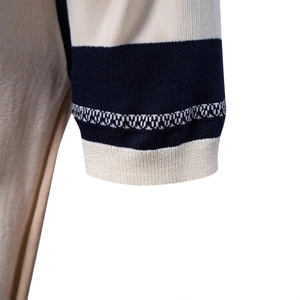 Short sleeve knit polo shirt with navy striped ribbed cuffs and wave jacquard detail