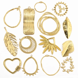 Detail view of assorted gold plated stainless steel charms including heart and leaf shapes