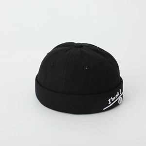 Detail of black cotton kids miki hat featuring white I'm ok smiley face embroidery