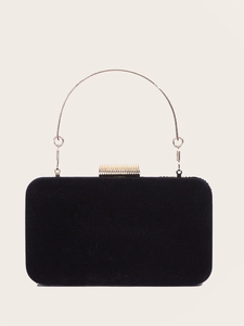 Front view of black velvet clutch with round gold handle and textured metal lock