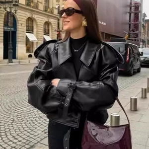 Women's vintage oversized black leather jacket with padded shoulders in a street style