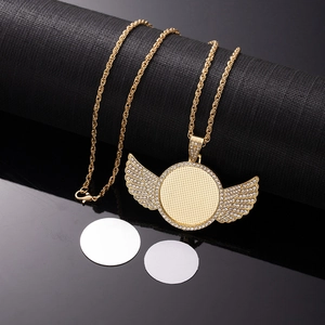Macro view of gold sublimation angel wing pendant with rhinestones and twist chain
