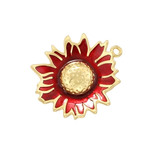 Macro detail of red enamel sunflower pendant with gold metal edges and central texture