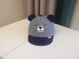Detailed view of navy blue striped baby sun hat with cute bear ears and embroidery