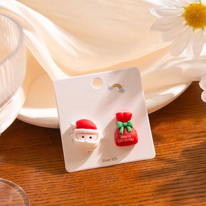 Detail view of asymmetric 925 silver Christmas earrings with Santa and gift bag
