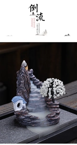 Macro view of Zen resin backflow incense burner showing smoke waterfall and miniature tree