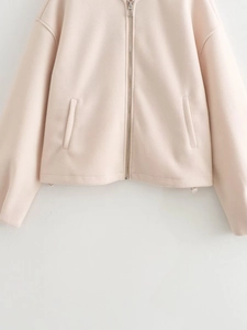 Detailed view of silver zipper, pockets and drawstring hem on women's casual jacket