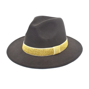 Detail of wool fedora hat featuring a wide flat brim and golden sequin decorative band