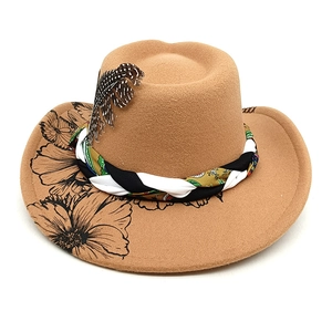 Detail of brown wool felt cowboy hat featuring floral print and woven feather band