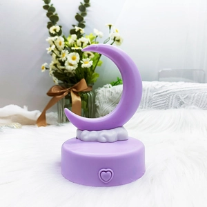 Purple crescent moon night light with heart button on plush white rug background