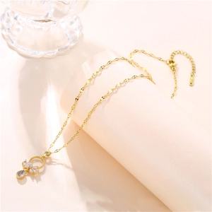 Elegant gold-tone necklace with a bowknot zircon pendant and a clear teardrop crystal