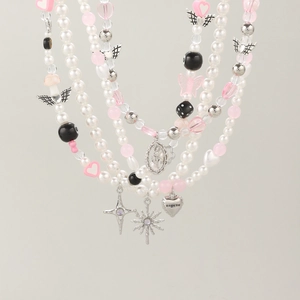 Detail view of multi-layered Y2K beaded necklace with butterfly and cross charms