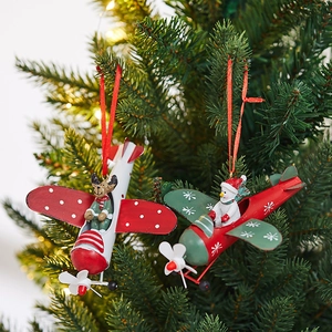 Iron plane Christmas ornaments featuring reindeer and snowman on a festive tree