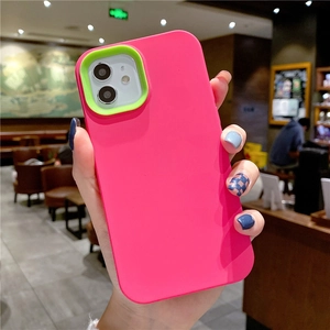 Bright pink liquid silicone phone case with contrasting neon green camera protection for iPhone.