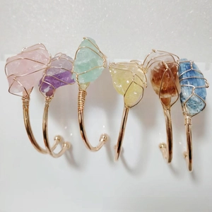 Detail of six assorted natural raw stone gold wire wrapped open bangles for women