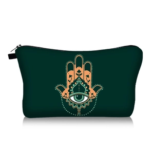 Detailed view of dark green cosmetic bag with Hamsa Hand and Evil Eye pattern print