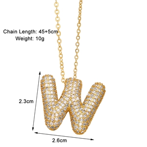 Detail view of gold letter W pendant necklace with zircon inlay and product dimensions