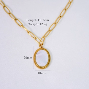Macro shot of gold paperclip chain necklace with white shell oval pendant and measurements