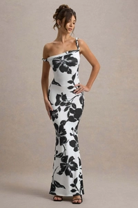 Detail view of one-shoulder slim fit dress featuring bold black floral print on white fabric