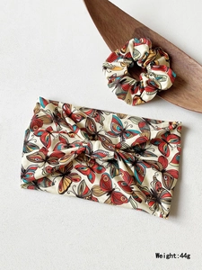 Detail of beige yoga headband and scrunchie set with colorful butterfly prints