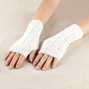 Close-up of white cable-knit fingerless gloves with soft textured pattern detail