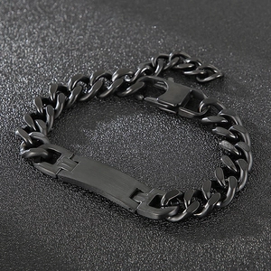 Vue détaillée d'un bracelet gourmette noir avec plaque en métal sur fond texturé