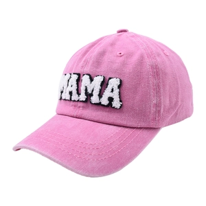 Detail of pink denim baseball cap showing white MAMA plush embroidery and fabric texture
