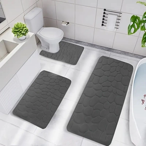 Deep grey 3-piece bathroom rug set with pebble texture on white tile floor