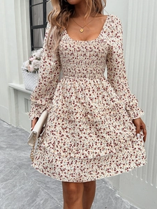Detail of red floral dress featuring square neck, long sleeves and ruffled hem