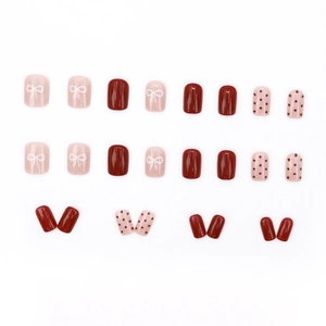 Short square press-on nails set with red polka dots and sweet pink bow designs
