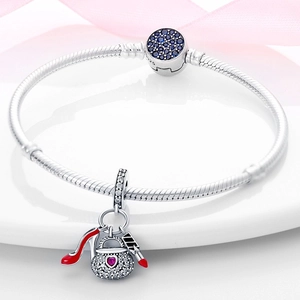Detailed view of 925 silver charm bracelet with red high heel and lipstick charms