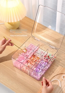 Detailed top view of a 9-grid clear acrylic storage box filled with colorful DIY beads