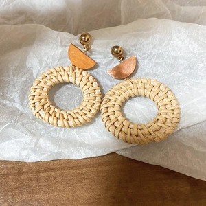 Detailed close-up showing handwoven rattan texture of bohemian style round drop earrings