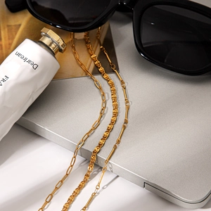 Detailed close-up of three-layer gold-plated stainless steel necklaces on a silver laptop