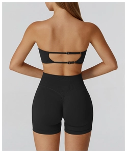 Detail view of black seamless yoga set featuring a back buckle bra and ruched lifting shorts