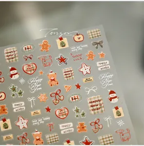 Détails de stickers à ongles de Noël avec ours mignons, bonhommes de neige et motifs