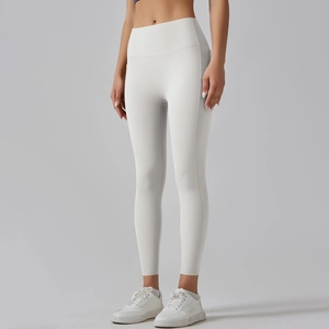 Close-up of white high-waisted yoga leggings with functional side pocket on the hip