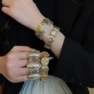 Detailed macro of vintage style metal bangles with heart, fish and infinity charms