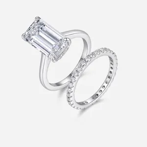 Detail view of emerald-cut moissanite silver ring set with micro-pave eternity band
