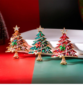 Detailed close-up of colorful enamel Christmas tree brooches with rhinestones and gold alloy