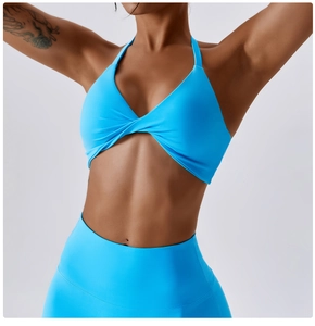 Detail of bright blue halter twist sports bra and high-waisted yoga leggings set