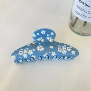 Sky blue hair claw clip with white floral patterns and sparkling champagne rhinestones