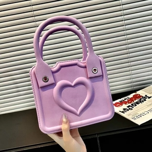 Detail of purple matte EVA handbag featuring a 3D heart-shaped embossed design