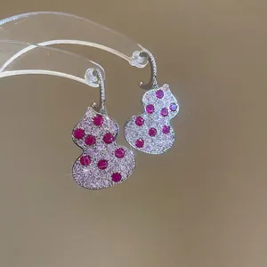 Silver-needle C-shaped gourd earrings with pink and red zircon stones on stand