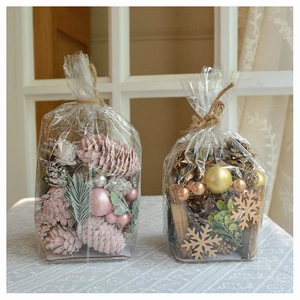 Detail of Christmas DIY pine cone decor sets with pink, silver, and gold festive ornaments